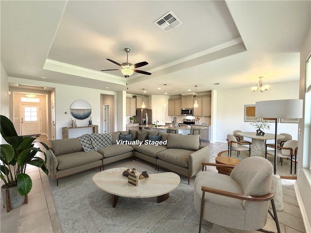 1030 Ocean Breeze St, Portland, TX 78374 - living room with a tray ceiling, a chandelier, light tile patterned floors, ornamental molding, and a ceiling fan