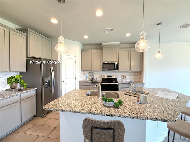 1030 Ocean Breeze St, Portland, TX 78374 - kitchen featuring appliances with stainless steel finishes, gray cabinetry, a kitchen breakfast bar, tasteful backsplash, and recessed lighting
