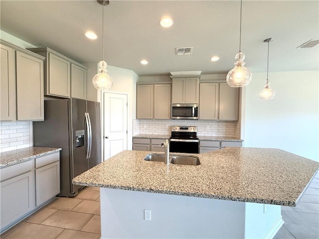 1030 Ocean Breeze St, Portland, TX 78374 - kitchen with stainless steel appliances, gray cabinetry, a center island with sink, tasteful backsplash, and recessed lighting