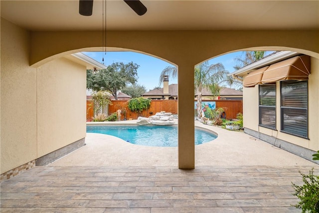 view of swimming pool featuring a patio area, a fenced backyard, a fenced in pool, and a ceiling fan