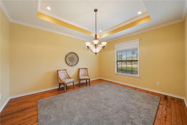 unfurnished room featuring dark wood-type flooring, a raised ceiling, and an inviting chandelier