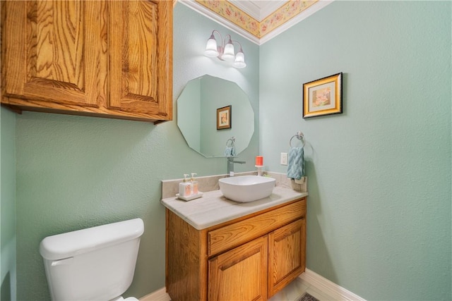 half bathroom featuring baseboards, vanity, and toilet