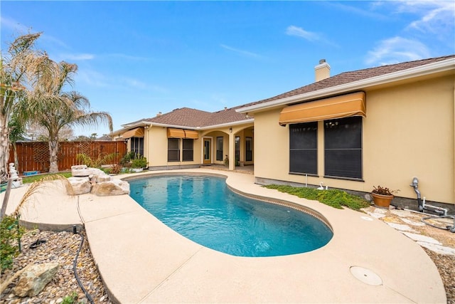 view of swimming pool featuring a patio, fence, and a fenced in pool