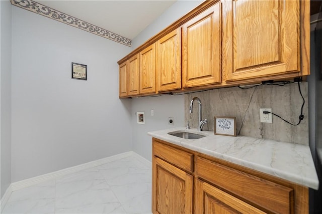 laundry area featuring washer hookup, marble finish floor, cabinet space, hookup for an electric dryer, and a sink