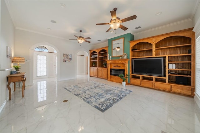 living room with visible vents, arched walkways, baseboards, a glass covered fireplace, and marble finish floor