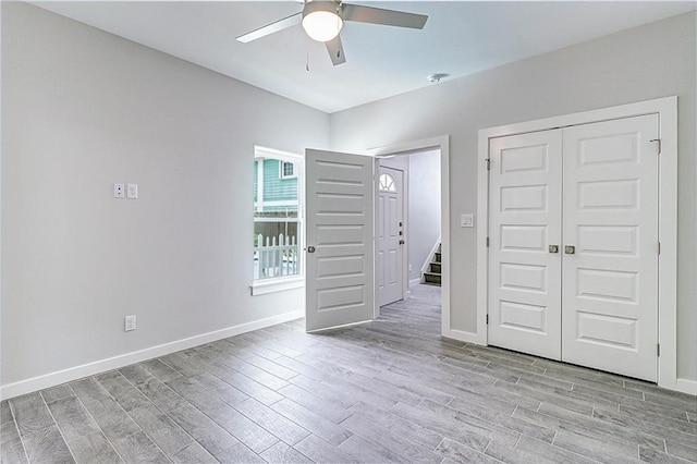 spare room featuring ceiling fan and light hardwood / wood-style floors