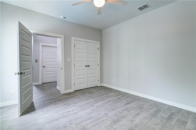 unfurnished bedroom featuring a closet, ceiling fan, and light hardwood / wood-style flooring