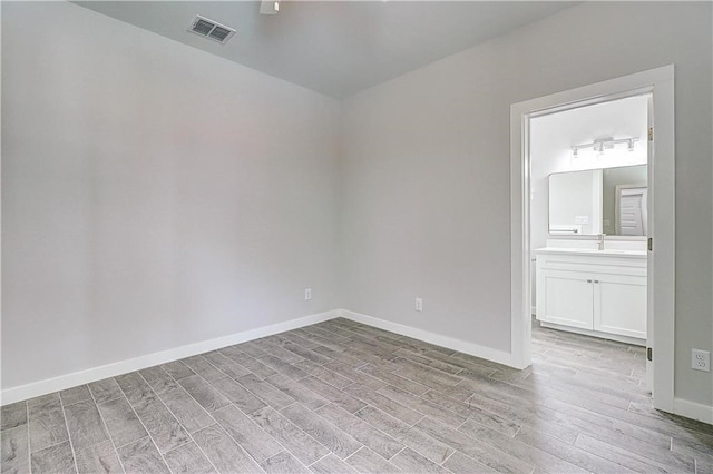 spare room with light hardwood / wood-style flooring