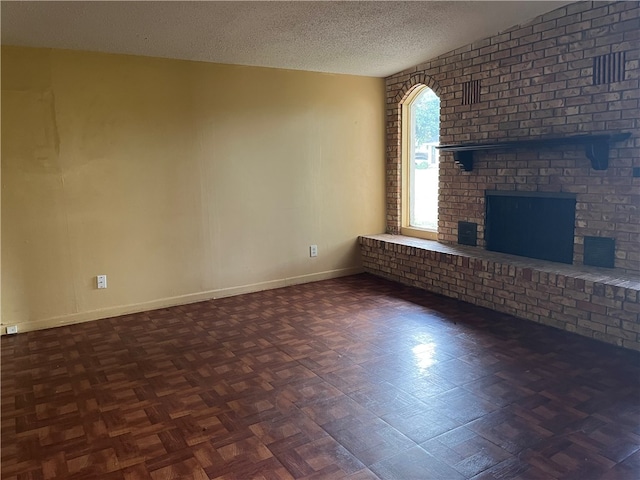 unfurnished living room with a textured ceiling, dark parquet flooring, and a fireplace