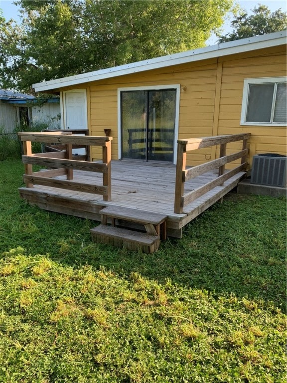 wooden terrace with central air condition unit and a lawn