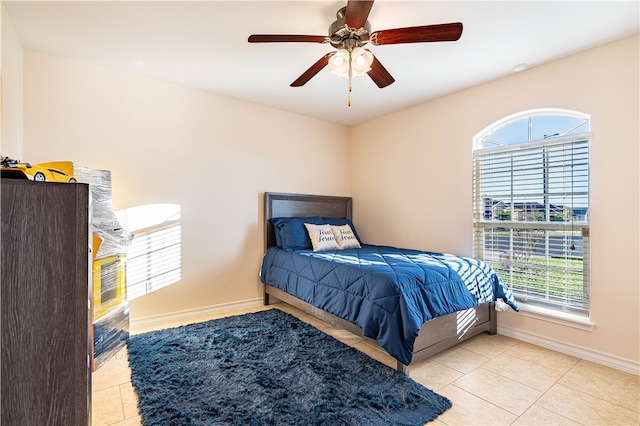 tiled bedroom with ceiling fan