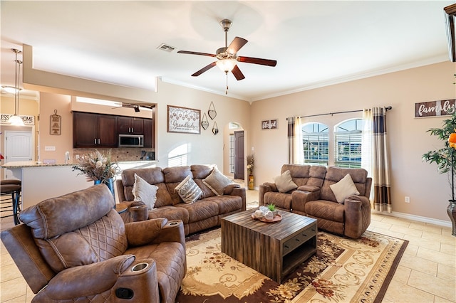 living room with ceiling fan, crown molding, and light tile patterned floors