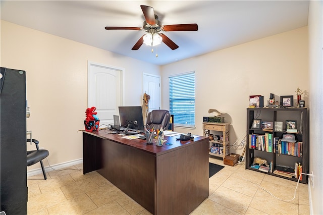 office featuring light tile patterned floors and ceiling fan