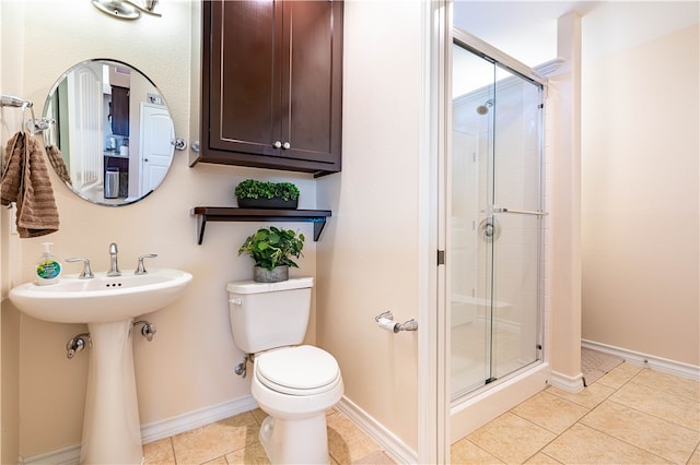 bathroom featuring walk in shower, tile patterned flooring, and toilet