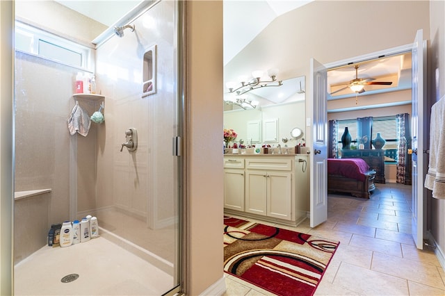 bathroom featuring ceiling fan, a shower with door, vanity, and lofted ceiling