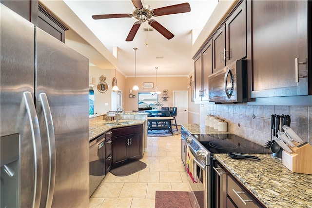 kitchen featuring hanging light fixtures, sink, dark brown cabinetry, and appliances with stainless steel finishes