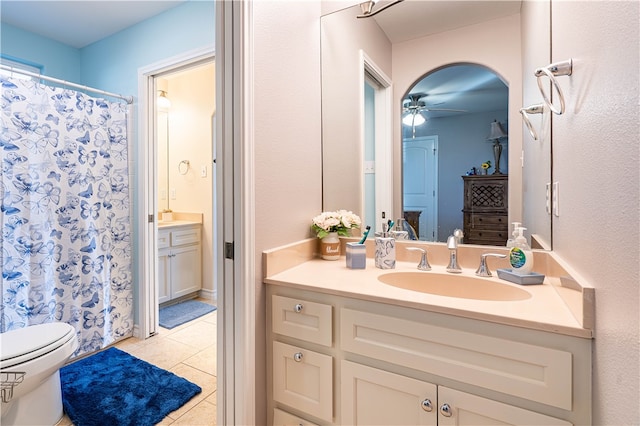 bathroom featuring toilet, vanity, tile patterned flooring, and ceiling fan