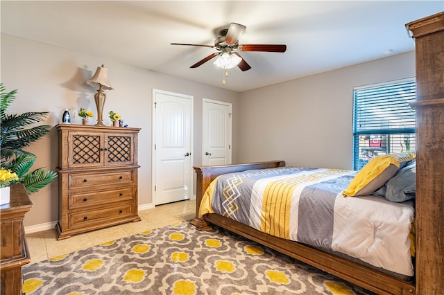 bedroom featuring light tile patterned flooring and ceiling fan