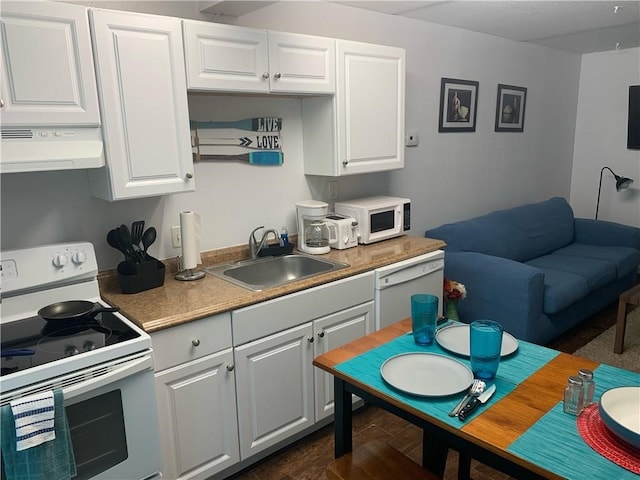 kitchen with range hood, white cabinetry, white appliances, and sink