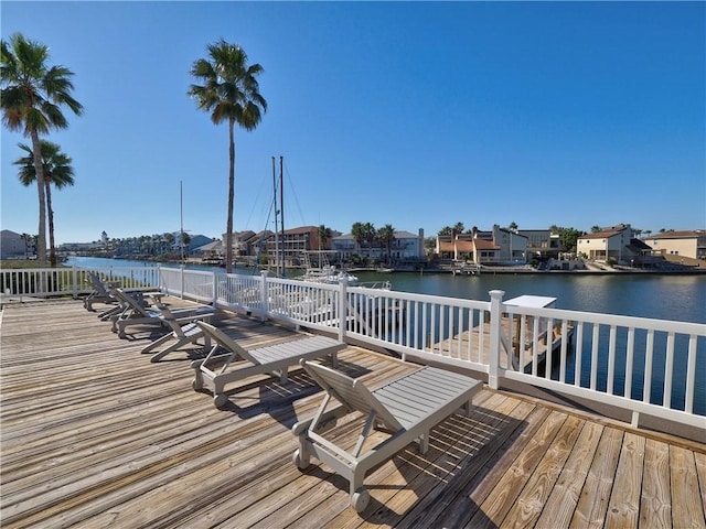 view of dock with a deck with water view