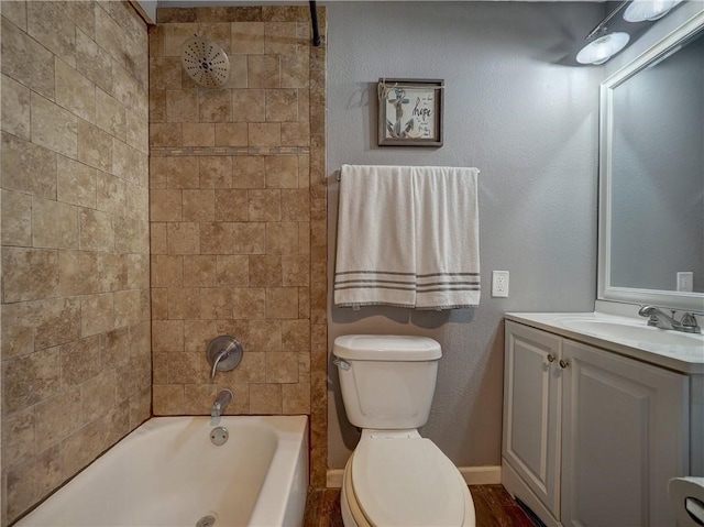 full bathroom with vanity, toilet, and tiled shower / bath combo