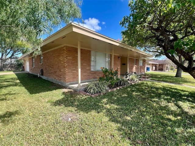 view of home's exterior with brick siding, a lawn, and a garage