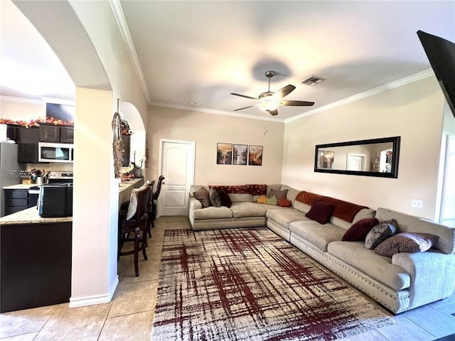 living room featuring ceiling fan, light tile patterned floors, and crown molding