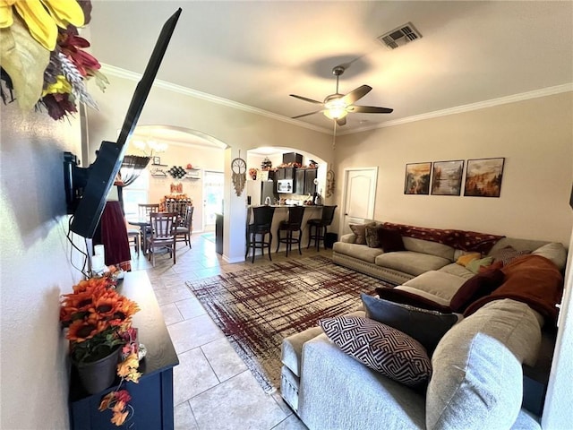 living room with ceiling fan, light tile patterned floors, and crown molding