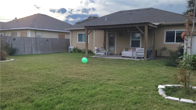 back of house featuring a patio area and a yard