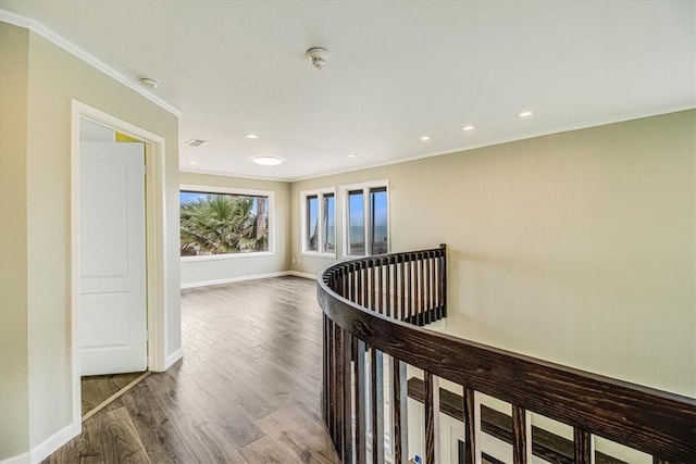 corridor featuring crown molding, an upstairs landing, wood finished floors, and baseboards