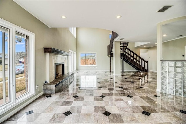 living room with visible vents, baseboards, recessed lighting, a fireplace, and stairs