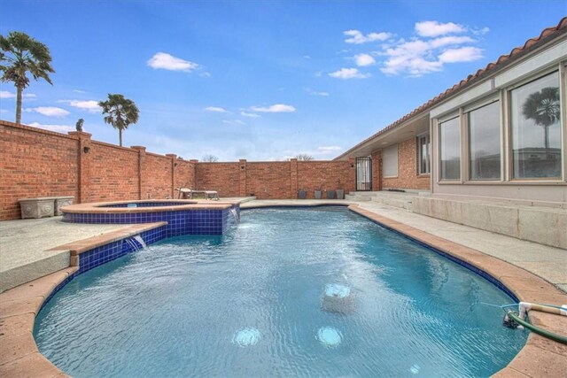 view of pool featuring a fenced in pool, an in ground hot tub, and a fenced backyard