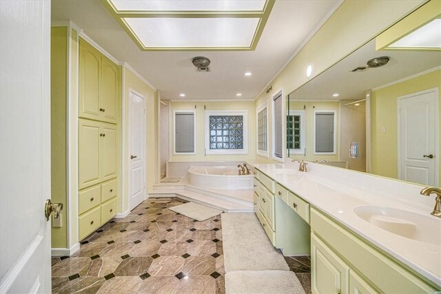 bathroom featuring a garden tub, crown molding, and a sink