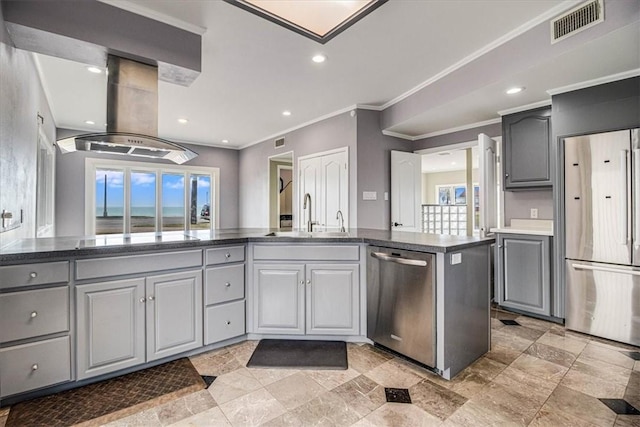 kitchen with island exhaust hood, stainless steel appliances, gray cabinetry, and visible vents