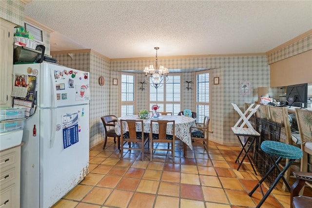 7033 Chiswick Dr, Corpus Christi, TX 78413 - dining room featuring wallpapered walls, a textured ceiling, a chandelier, crown molding, and light tile patterned flooring