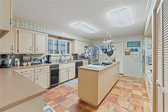 7033 Chiswick Dr, Corpus Christi, TX 78413 - kitchen with black appliances, a center island, a sink, a textured ceiling, and light countertops