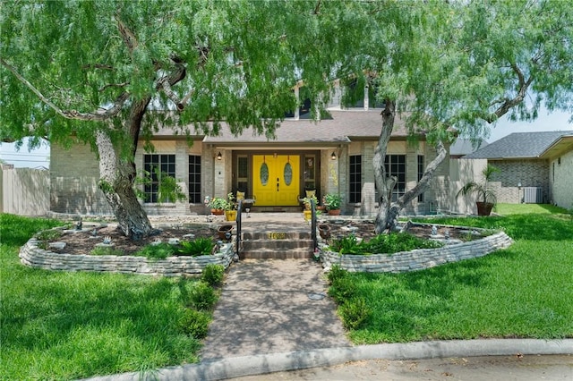 7033 Chiswick Dr, Corpus Christi, TX 78413 - view of front of house with a front lawn and brick siding