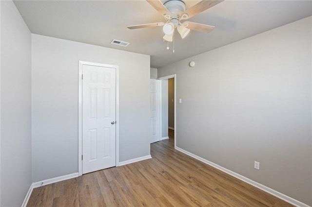 unfurnished bedroom with ceiling fan, a closet, and light hardwood / wood-style flooring