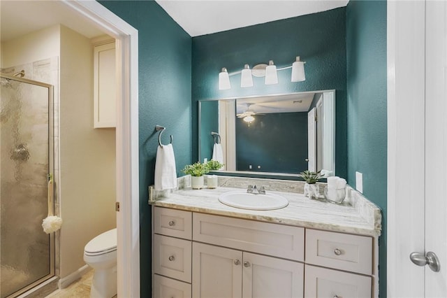 bathroom featuring vanity, a shower with shower door, and toilet