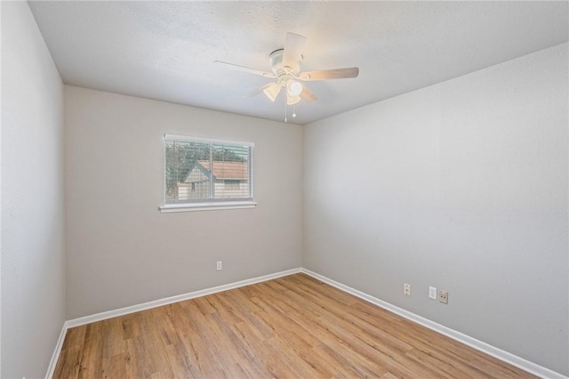 unfurnished room featuring light hardwood / wood-style flooring and ceiling fan