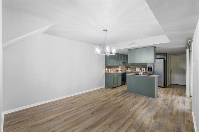 kitchen featuring wood-type flooring, black dishwasher, decorative backsplash, hanging light fixtures, and stainless steel fridge with ice dispenser