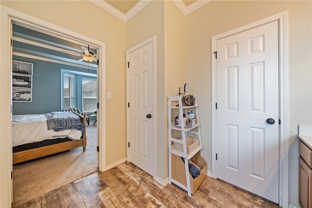 interior space with a closet, ornamental molding, and light hardwood / wood-style flooring