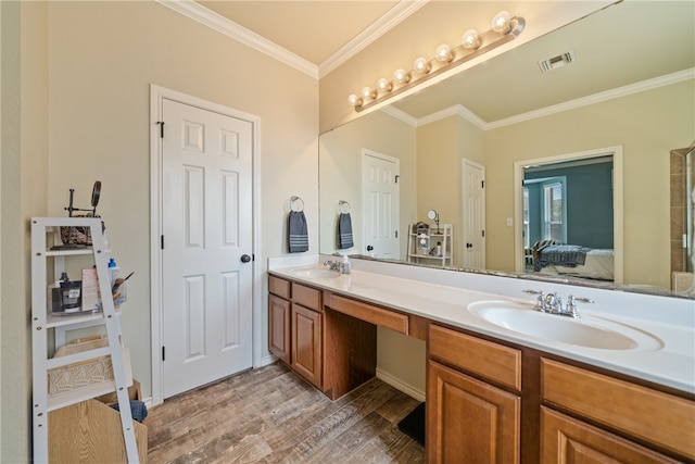 bathroom featuring wood-type flooring, vanity, and ornamental molding