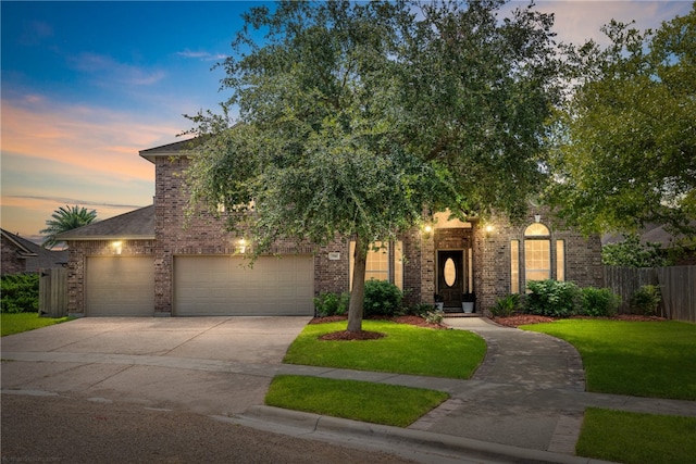 view of front of house with a garage and a yard