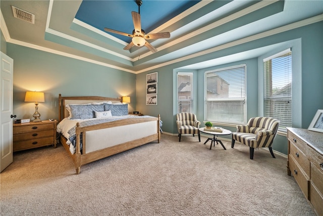 bedroom with ceiling fan, a raised ceiling, and carpet