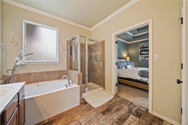 bathroom featuring vanity, shower with separate bathtub, hardwood / wood-style floors, and crown molding