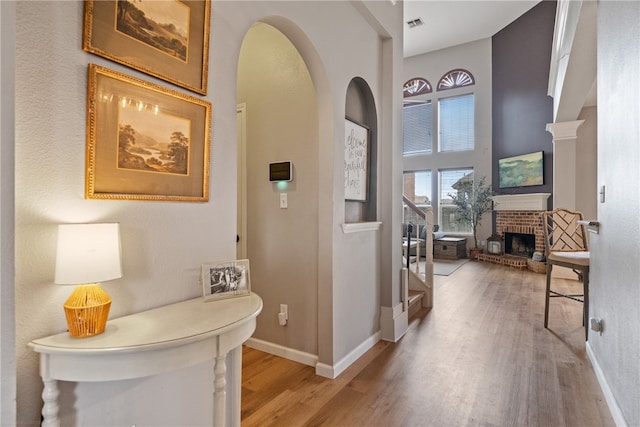 hallway featuring a towering ceiling and hardwood / wood-style floors