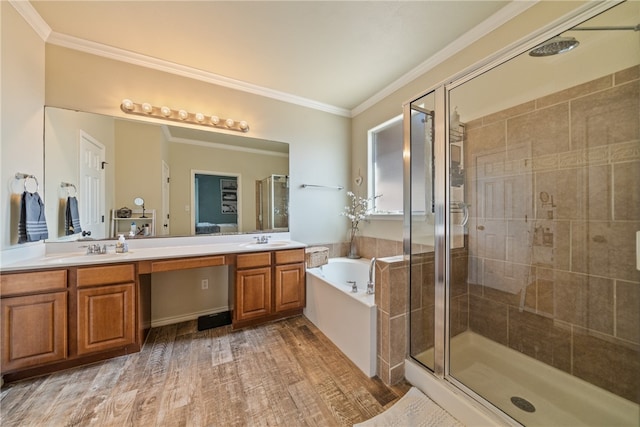 bathroom featuring independent shower and bath, vanity, hardwood / wood-style floors, and crown molding