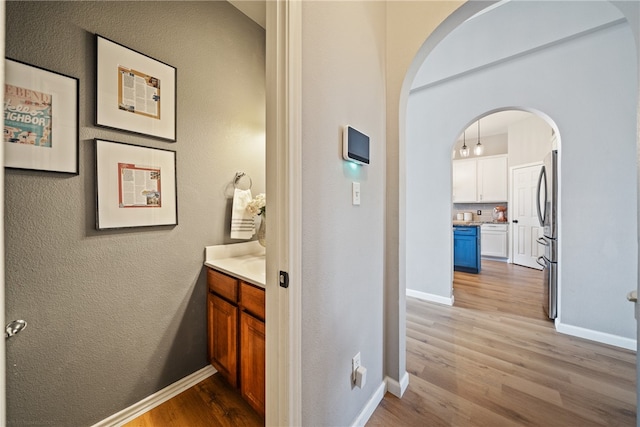 hallway with light hardwood / wood-style floors