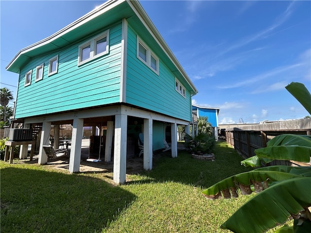 view of home's exterior with a lawn and central AC unit